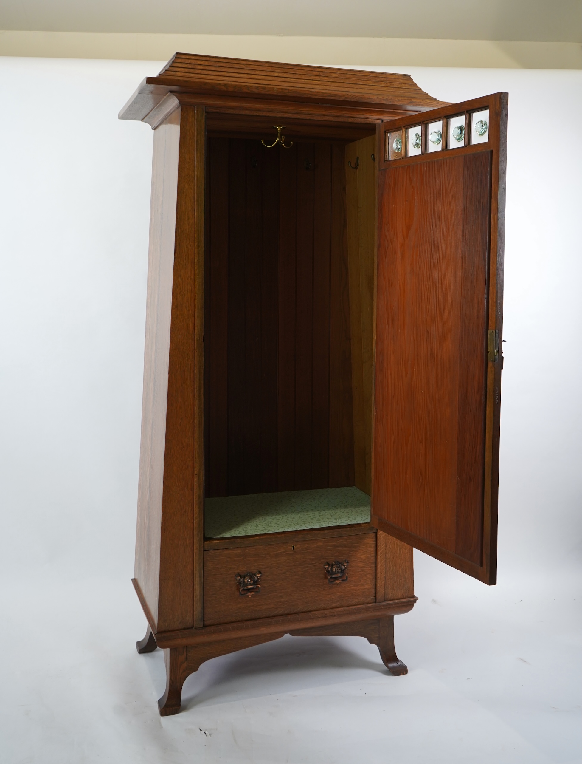 Manner of Liberty & Co: An Arts and Crafts Egyptian revival copper mounted oak wardrobe